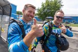 Tandem student and instructor give the camera a thumbs up before boarding the airplane.