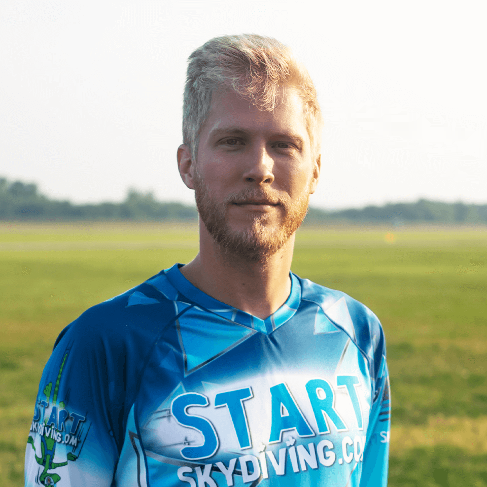 Blonde male with reddish beard wearing Start Skydiving jersey named Thomas Birdwell